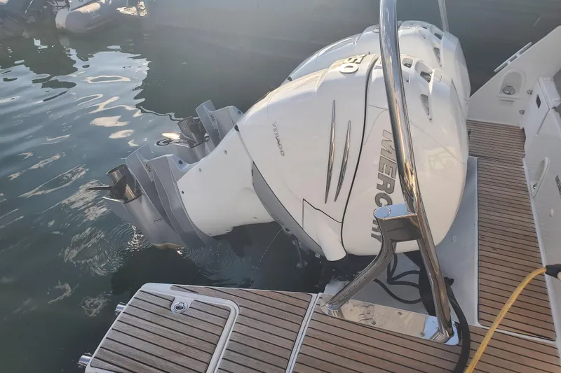  Yacht Photos Pics 2021 Beneteau Flyer 10 with twin Mercury outboard engines, docked on wooden deck.