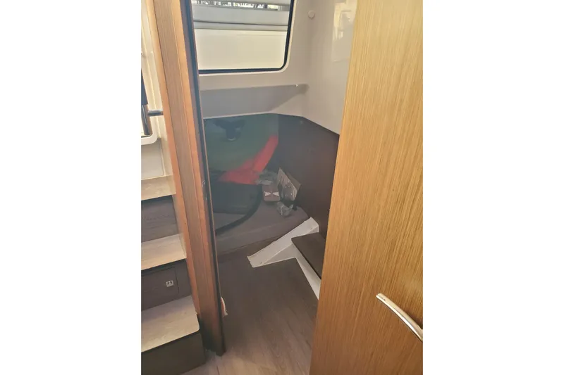  Yacht Photos Pics Interior cabin view of 2021 Beneteau Flyer 10 boat, featuring wooden finishes and compact design.