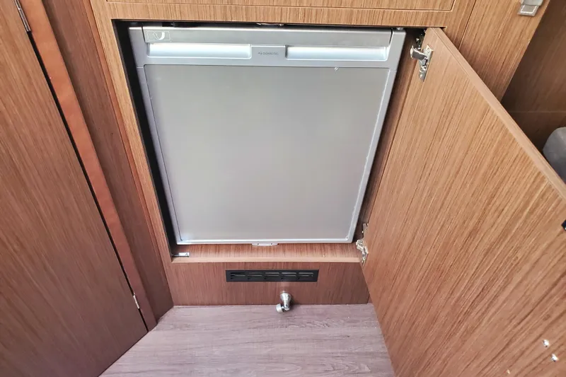  Yacht Photos Pics 2021 Beneteau Flyer 10 interior with built-in Dometic refrigerator.