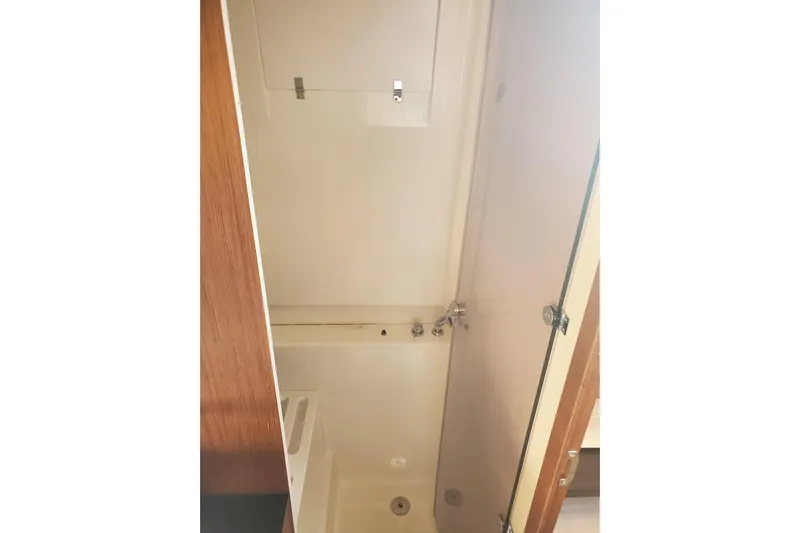  Yacht Photos Pics Interior view of 2021 Beneteau Flyer 10 bathroom with shower and wooden accents.