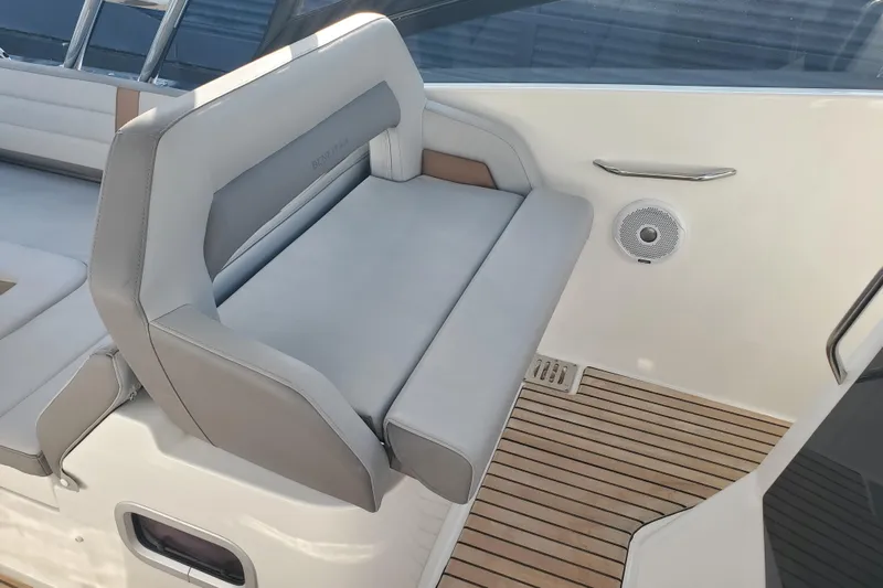  Yacht Photos Pics 2021 Beneteau Flyer 10 boat interior with cushioned seating and teak flooring.