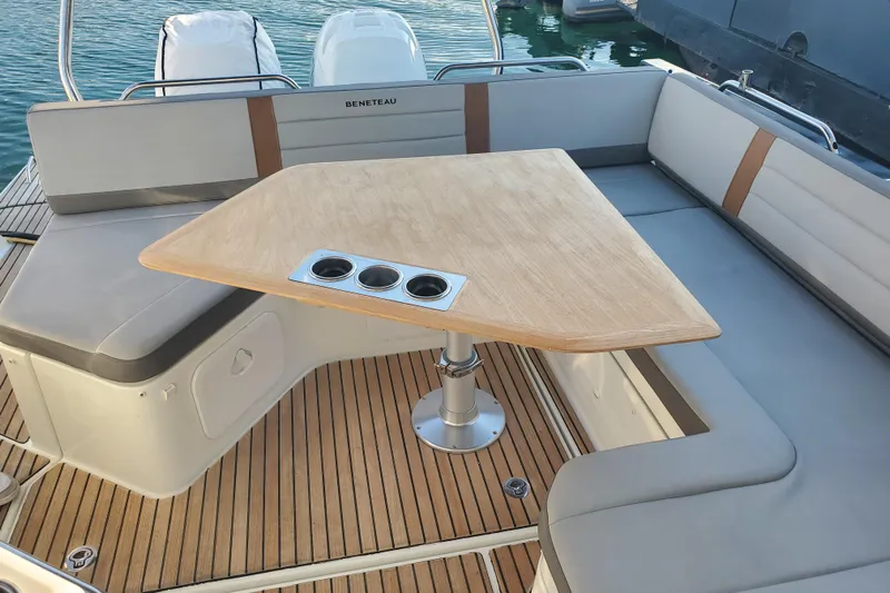  Yacht Photos Pics Beneteau Flyer 10, 2021 model, featuring a stylish deck seating area with a wooden table.