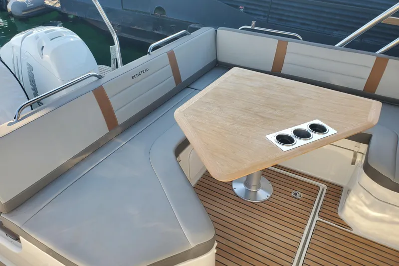  Yacht Photos Pics Beneteau Flyer 10, 2021 model, featuring a stylish deck seating area with a wooden table.