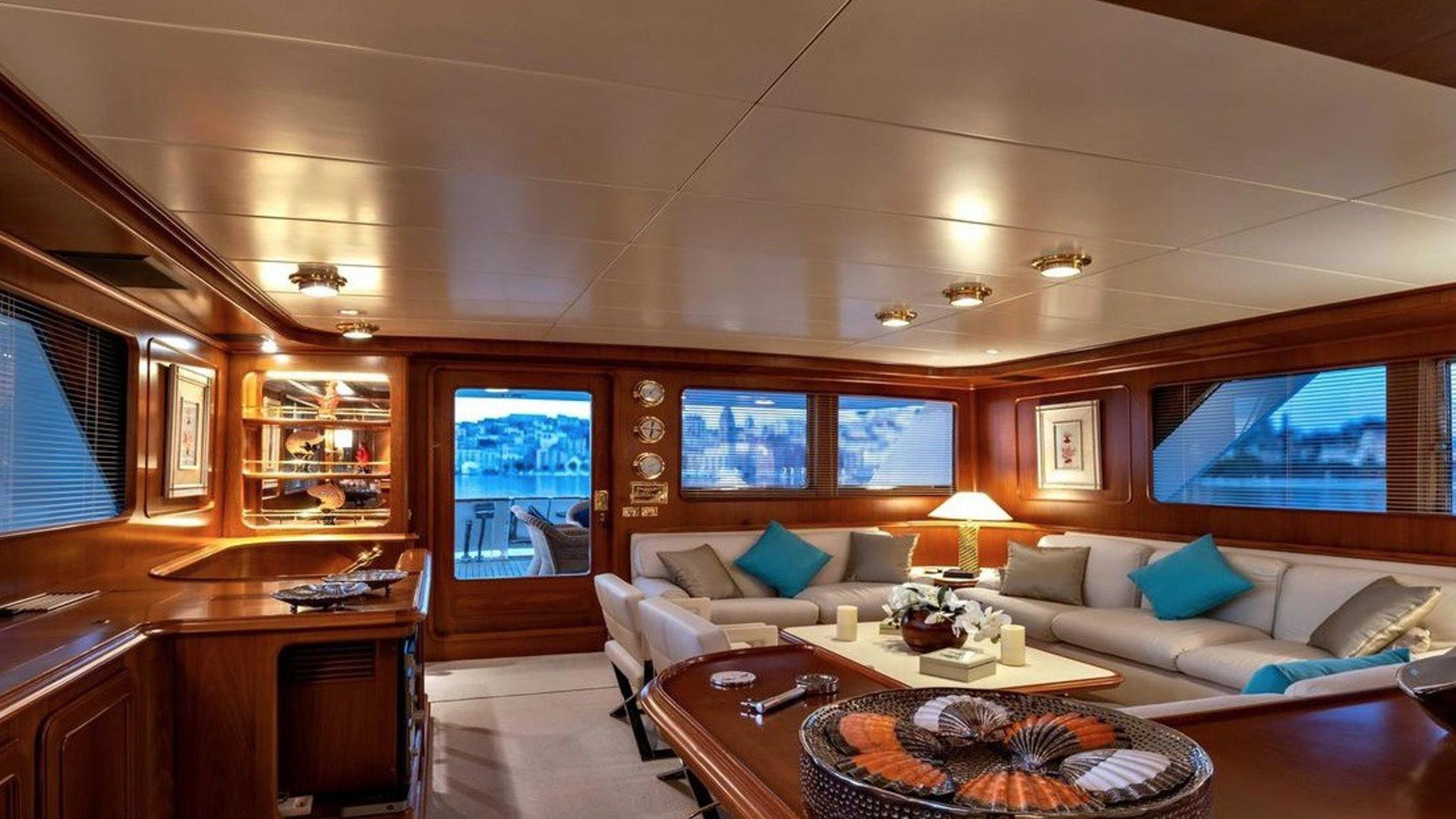 Luxurious 1987 Codecasa yacht interior with elegant wood finishes and plush seating.