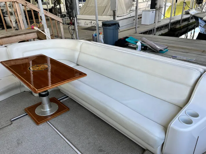  Yacht Photos Pics Luxurious seating area on a 2003 Sea Ray 460 Sundancer yacht with wooden table.