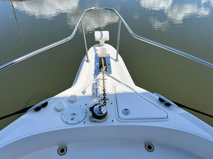  Yacht Photos Pics Bow of 2003 Sea Ray 460 Sundancer yacht with anchor chain and calm water reflection.