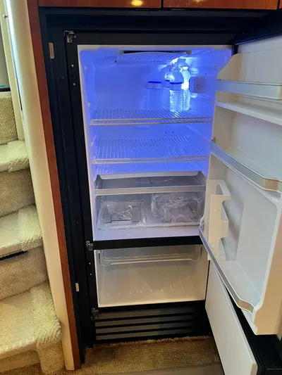  Yacht Photos Pics Refrigerator inside 2003 Sea Ray 460 Sundancer yacht, open with blue interior light.