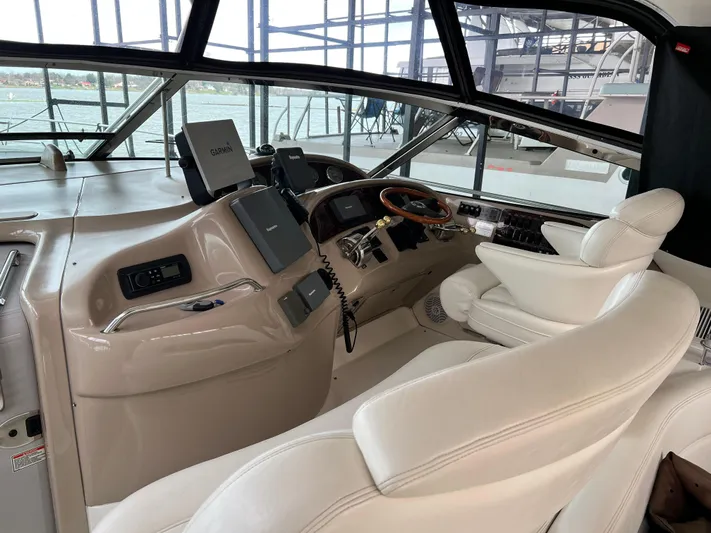  Yacht Photos Pics 2003 Sea Ray 460 Sundancer helm with leather seating and navigation equipment.