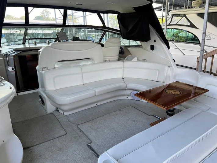  Yacht Photos Pics Interior of 2003 Sea Ray 460 Sundancer yacht with white seating and wooden table.