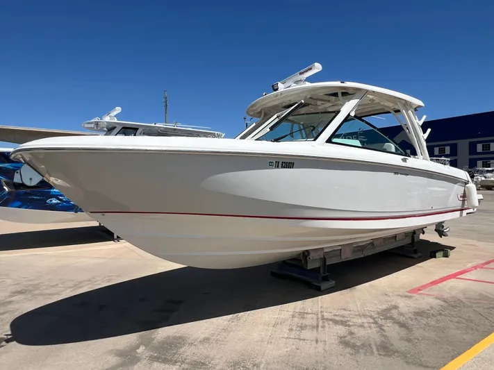  Yacht Photos Pics 2017 Boston Whaler 320 Vantage boat on display in a marina setting.