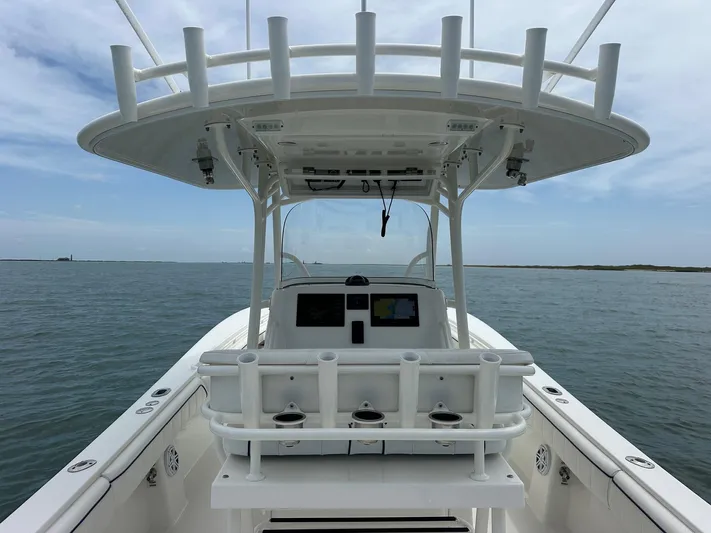  Yacht Photos Pics 2016 Regulator center console boat on open water, featuring a spacious helm and rod holders.