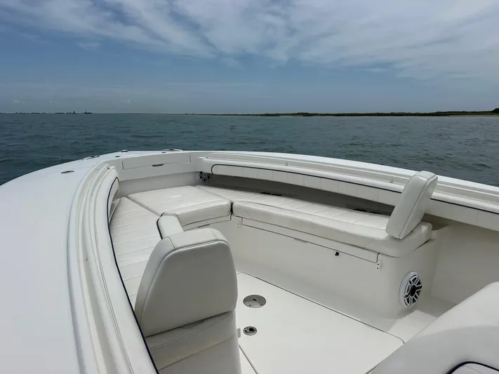  Yacht Photos Pics 2016 Regulator Center Console boat with white seating, on calm ocean waters.