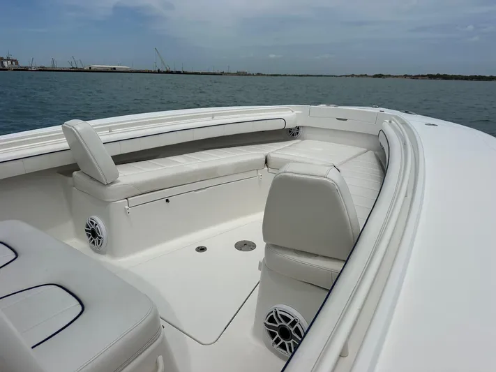  Yacht Photos Pics 2016 Regulator center console boat with white seating and ocean backdrop.