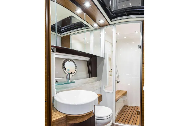 Courageous Yacht Photos Pics Manufacturer Provided Image: 2020 Tiara Yachts C53 Coupe bathroom with modern fixtures and wooden accents.