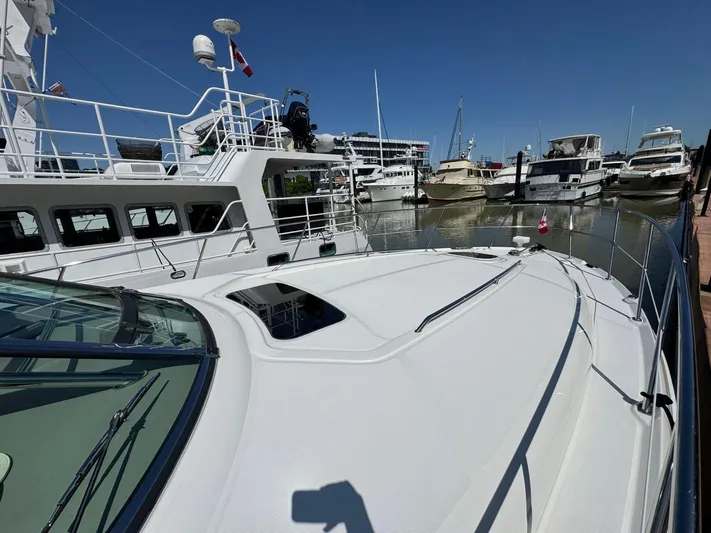  Yacht Photos Pics 2007 Sea Ray 400 Sundancer yacht docked in a marina under clear blue skies.