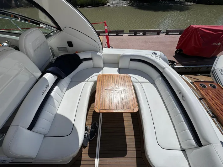  Yacht Photos Pics 2007 Sea Ray 400 Sundancer yacht with white seating and wooden table on deck.