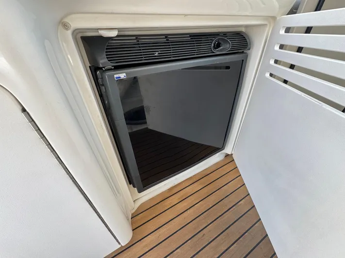  Yacht Photos Pics Mini fridge on 2007 Sea Ray 400 Sundancer yacht, wooden deck flooring.