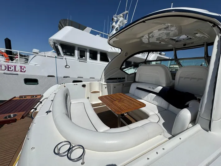  Yacht Photos Pics 2007 Sea Ray 400 Sundancer yacht with spacious seating and wooden table, docked beside another vessel.