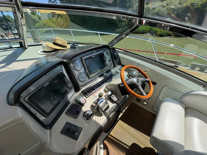  Yacht Photos Pics Helm of 2007 Sea Ray 400 Sundancer with modern controls and wooden steering wheel.