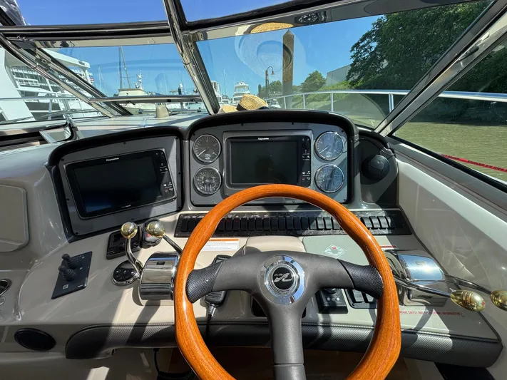  Yacht Photos Pics Helm of 2007 Sea Ray 400 Sundancer with wooden steering wheel and navigation displays.