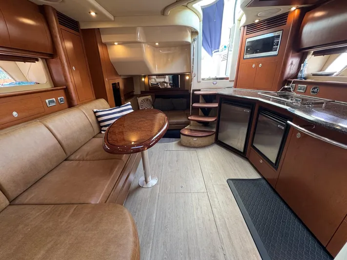  Yacht Photos Pics Luxurious interior of 2007 Sea Ray 400 Sundancer yacht with modern kitchen and seating area.
