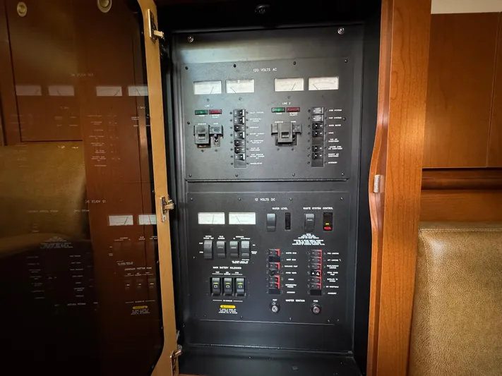 Yacht Photos Pics Electrical panel inside 2007 Sea Ray 400 Sundancer yacht, showcasing circuit breakers and controls.