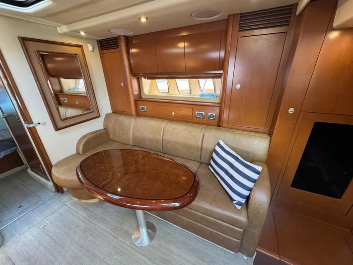  Yacht Photos Pics Luxurious interior of 2007 Sea Ray 400 Sundancer with leather seating and wooden table.