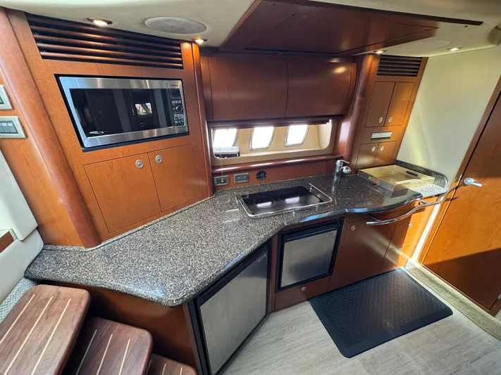  Yacht Photos Pics Luxurious kitchen interior of 2007 Sea Ray 400 Sundancer yacht with modern amenities.