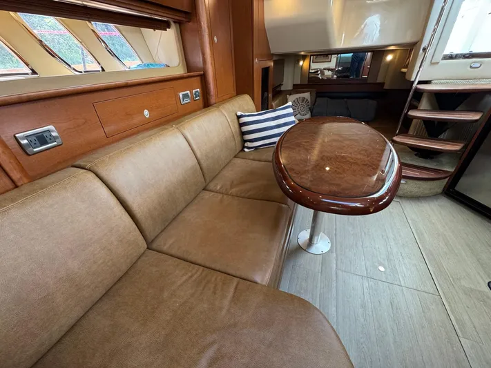  Yacht Photos Pics Interior of 2007 Sea Ray 400 Sundancer yacht with leather seating and wooden table.