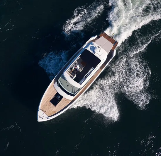  Yacht Photos Pics Aerial view of 2023 Delta Powerboats 33 Coupe cruising on open water.