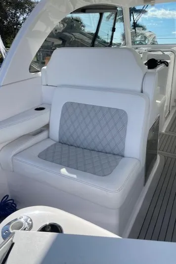  Yacht Photos Pics 2022 Southport 33 DC boat interior with white cushioned seating and modern design.