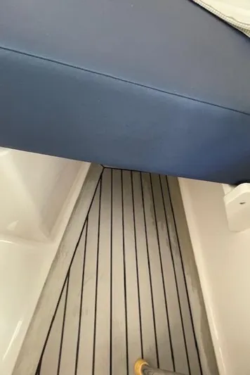  Yacht Photos Pics 2022 Southport 33 DC boat interior with blue seating and striped flooring.