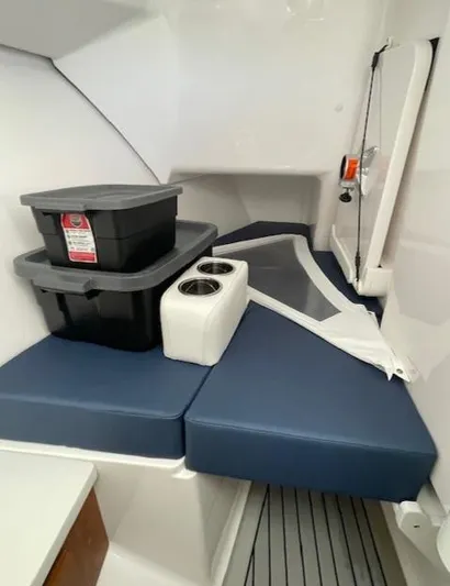  Yacht Photos Pics 2022 Southport 33 DC cabin interior with storage bins and blue cushions.