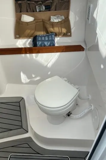  Yacht Photos Pics 2022 Southport 33 DC boat interior with toilet and storage compartments.