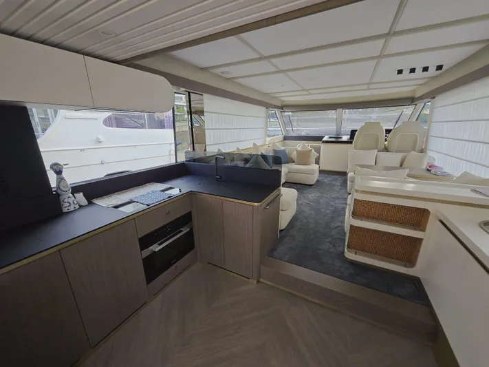  Yacht Photos Pics Luxurious interior of 2024 Azimut Magellano 60 yacht with modern kitchen and seating area.