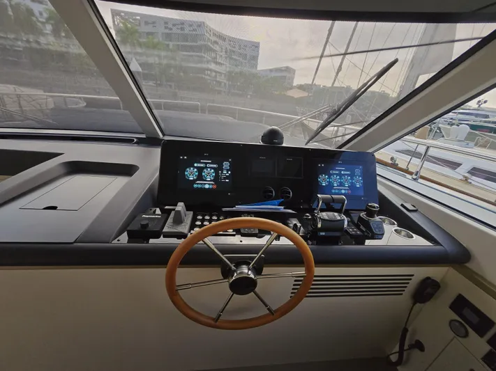  Yacht Photos Pics Helm of 2024 Azimut Magellano 60 yacht with modern controls and navigation screens.