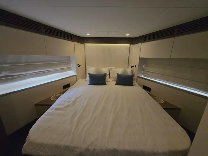  Yacht Photos Pics Luxurious bedroom interior of 2024 Azimut Magellano 60 yacht with elegant bedding.