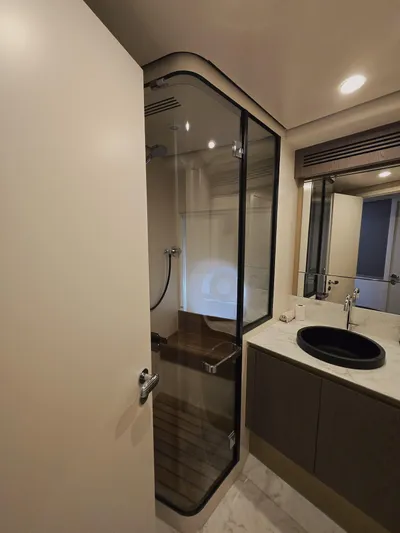  Yacht Photos Pics Luxurious bathroom in 2024 Azimut Magellano 60 yacht with modern shower and sleek design.