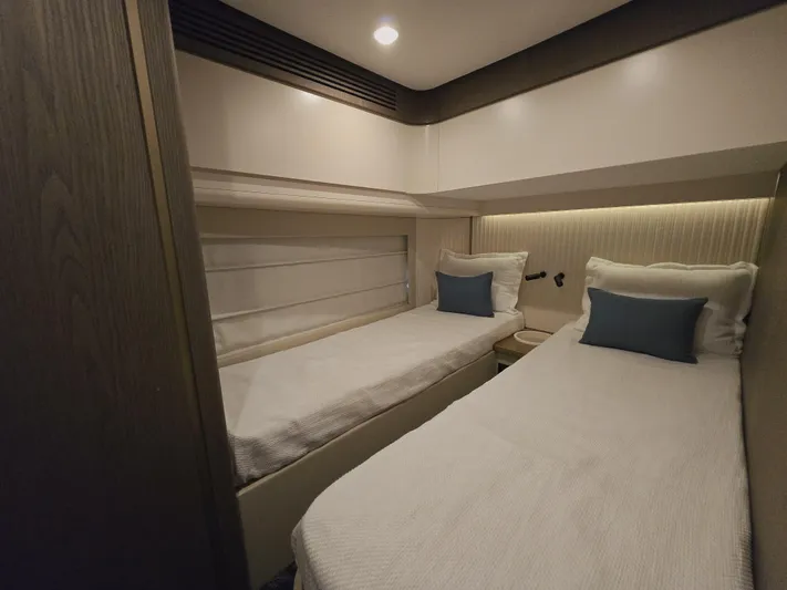  Yacht Photos Pics Twin cabin interior of 2024 Azimut Magellano 60 yacht, featuring modern design and cozy bedding.