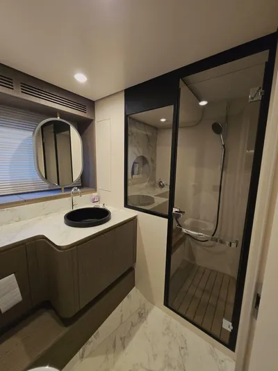  Yacht Photos Pics Luxurious bathroom in 2024 Azimut Magellano 60 yacht with modern fixtures and elegant design.