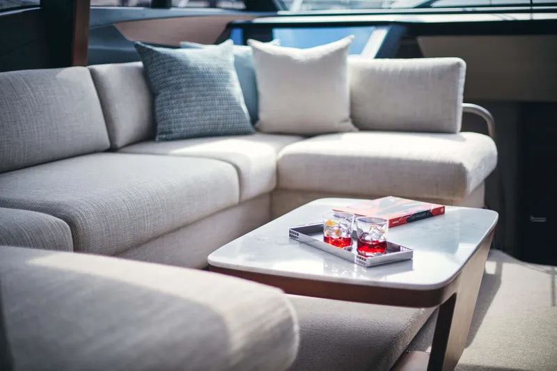  Yacht Photos Pics Luxurious interior of 2025 Princess S65 yacht with elegant seating and table setup.