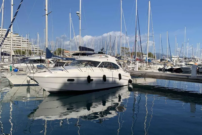 Ocilo Yacht Photos Pics 2005 Sealine SC 39 yacht docked in a marina, surrounded by sailboats.
