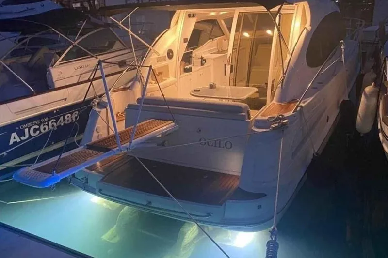 Ocilo Yacht Photos Pics 2005 Sealine SC 39 yacht docked at night with underwater lights.