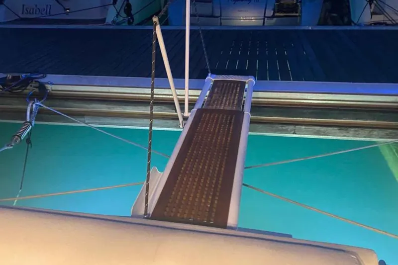 Ocilo Yacht Photos Pics Gangway of a 2005 Sealine SC 39 yacht leading to a dock at night.