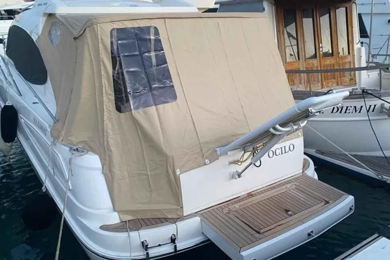 Ocilo Yacht Photos Pics 2005 Sealine SC 39 yacht with beige cover docked at marina.