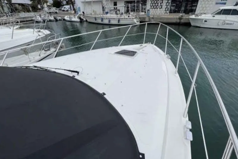 Ocilo Yacht Photos Pics 2005 Sealine SC 39 yacht docked in a marina, showcasing sleek design and spacious deck.