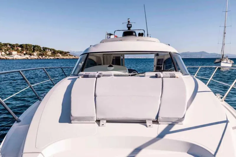 Ocilo Yacht Photos Pics 2005 Sealine SC 39 yacht on calm sea with scenic coastal background.