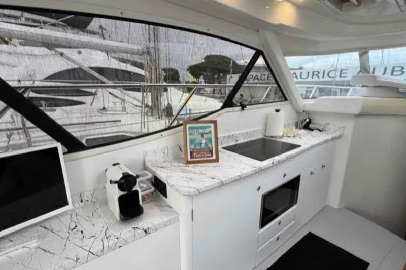 Ocilo Yacht Photos Pics Interior of 2005 Sealine SC 39 yacht with modern kitchen and marble countertops.