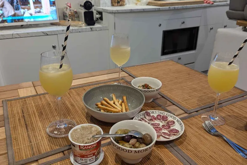 Ocilo Yacht Photos Pics Cozy dining setup on a 2005 Sealine SC 39 yacht with snacks and drinks.