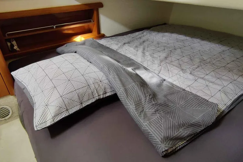 Ocilo Yacht Photos Pics Cozy cabin bed with geometric-patterned bedding in a 2005 Sealine SC 39 yacht.